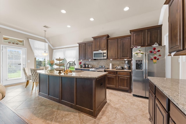 kitchen featuring light stone counters, stainless steel appliances, sink, decorative light fixtures, and lofted ceiling