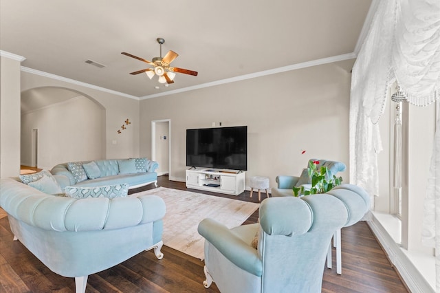 living room with ornamental molding, ceiling fan, and dark wood-type flooring