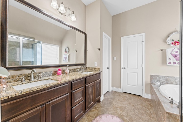 bathroom featuring tile patterned floors, vanity, and shower with separate bathtub