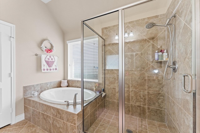 bathroom with tile patterned flooring, independent shower and bath, and vaulted ceiling