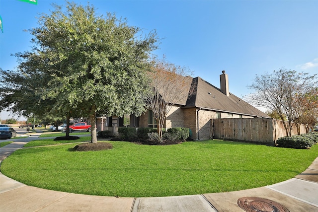 view of side of property featuring a yard