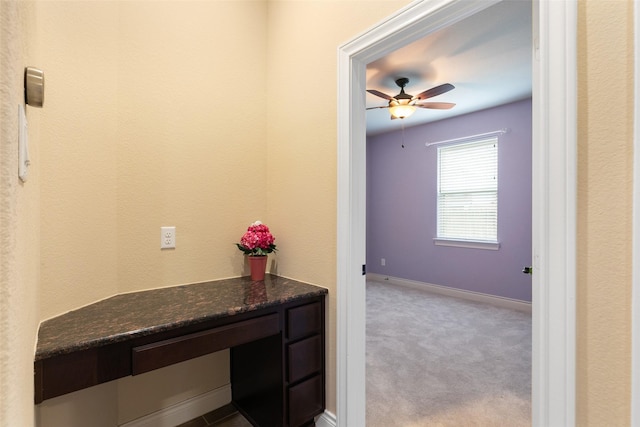 corridor featuring light colored carpet