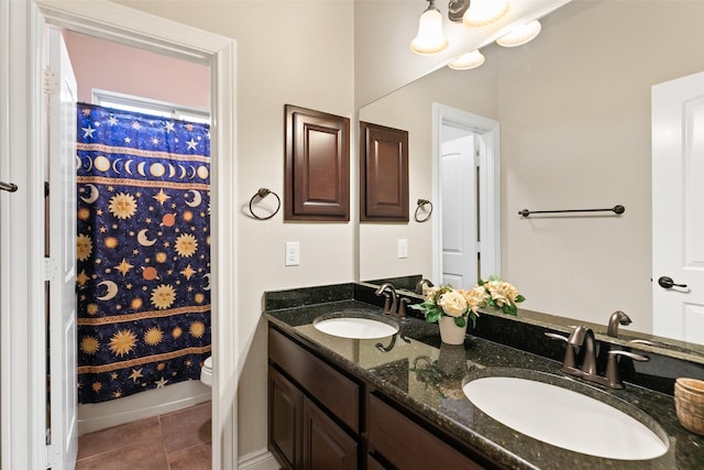 bathroom with tile patterned floors, vanity, and toilet