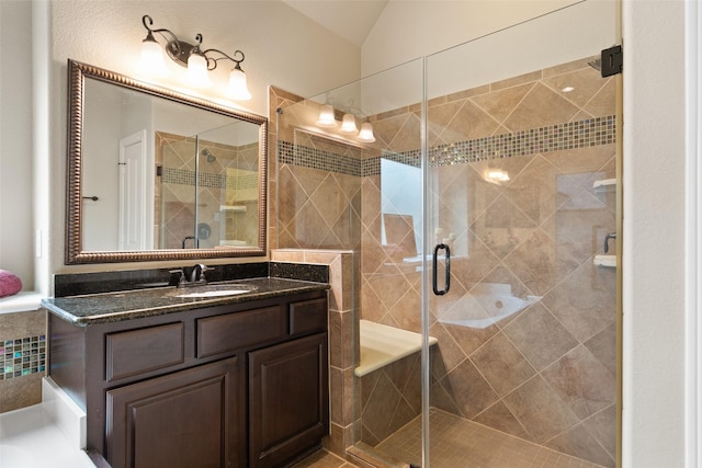 bathroom featuring vanity, a shower with door, and lofted ceiling