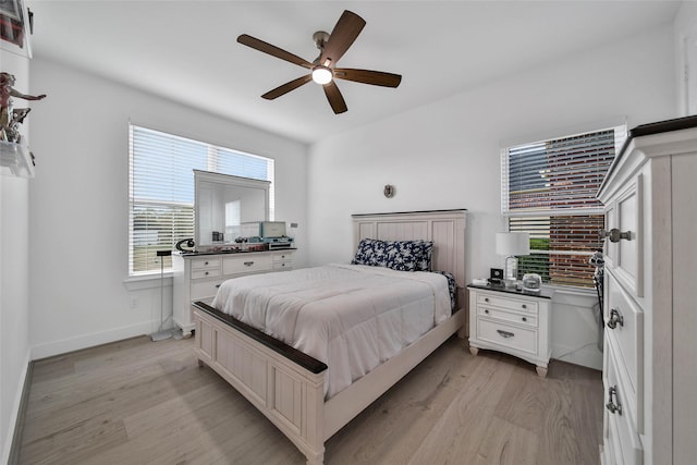 bedroom with light wood-type flooring and ceiling fan