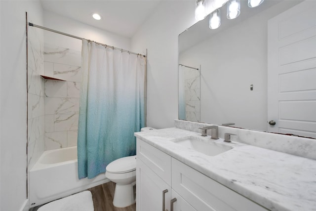 full bathroom featuring hardwood / wood-style floors, shower / bath combo, toilet, and vanity