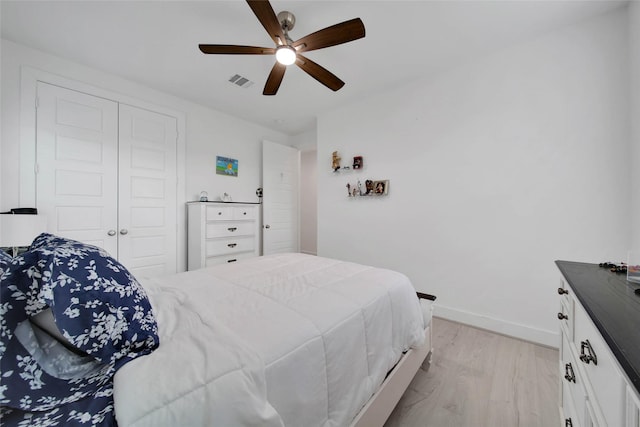 bedroom featuring ceiling fan, a closet, and light hardwood / wood-style flooring