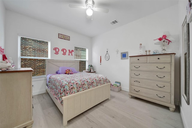 bedroom with multiple windows, ceiling fan, and light hardwood / wood-style floors