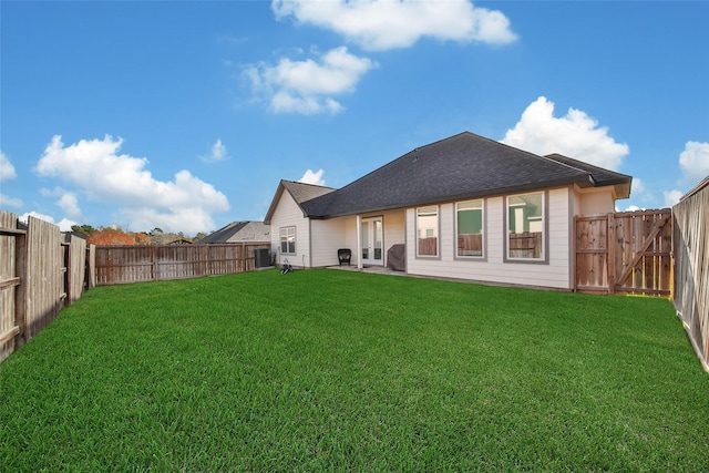 back of property featuring a lawn and cooling unit