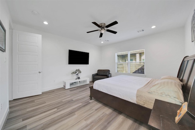 bedroom with ceiling fan and light hardwood / wood-style floors