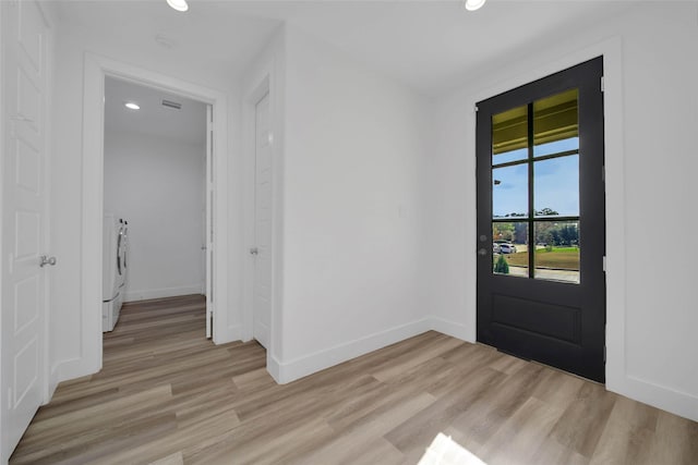 entryway featuring washer / clothes dryer and light wood-type flooring