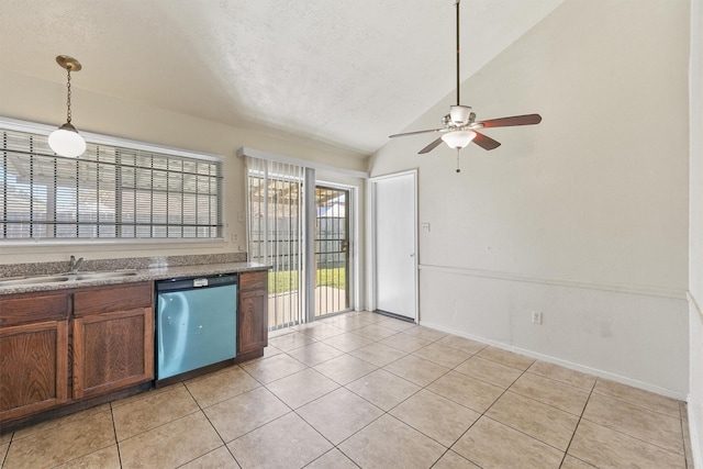 kitchen with sink, light tile patterned floors, pendant lighting, dishwasher, and lofted ceiling