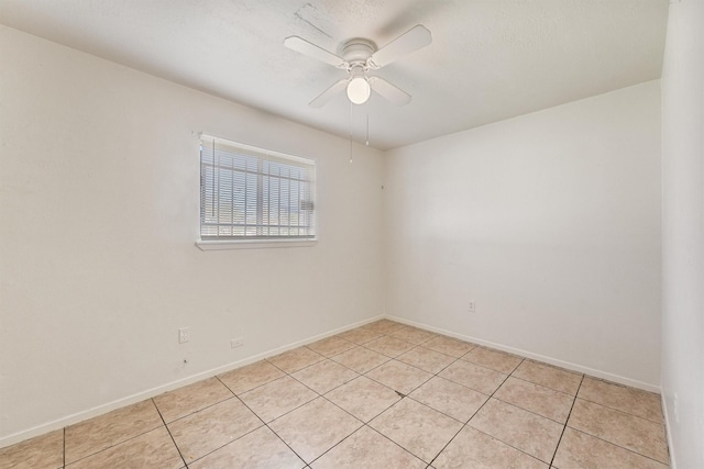 unfurnished room featuring ceiling fan and light tile patterned flooring