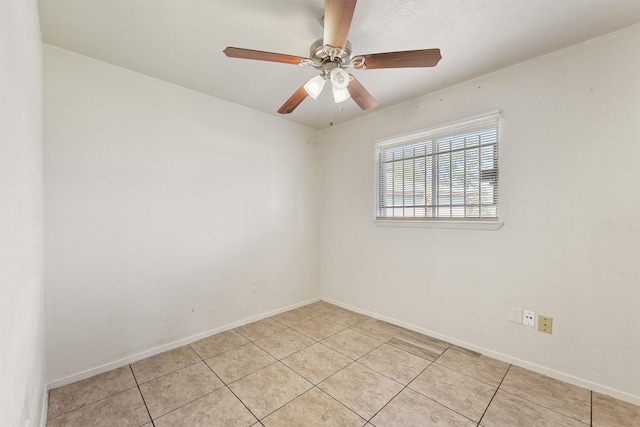 empty room featuring ceiling fan and light tile patterned floors