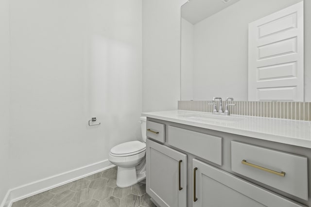 bathroom featuring tile patterned floors, vanity, and toilet