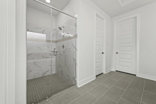 bathroom featuring a shower with door