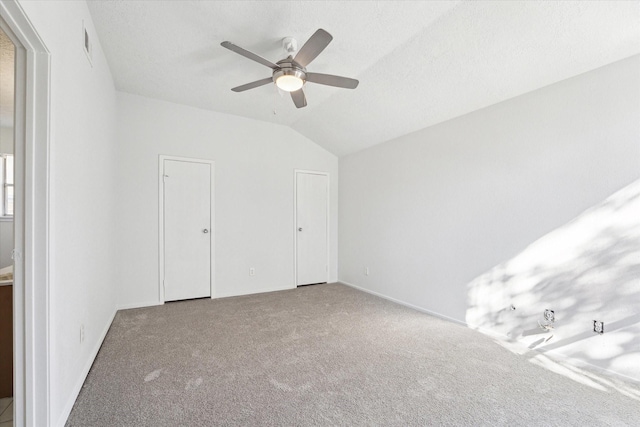 unfurnished bedroom with carpet flooring, ceiling fan, and lofted ceiling