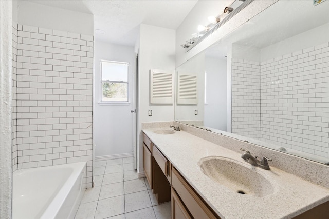 bathroom featuring tile patterned flooring, vanity, and tiled shower / bath