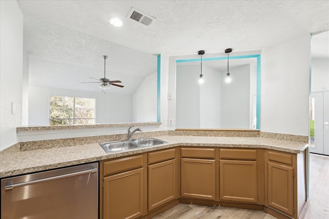 kitchen featuring ceiling fan, sink, stainless steel dishwasher, kitchen peninsula, and pendant lighting