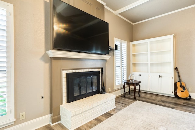 living room featuring a fireplace, wood-type flooring, plenty of natural light, and ornamental molding