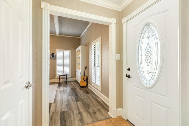 foyer with ornamental molding and hardwood / wood-style flooring