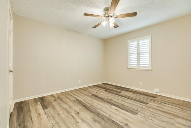 unfurnished room featuring a textured ceiling and light wood-type flooring