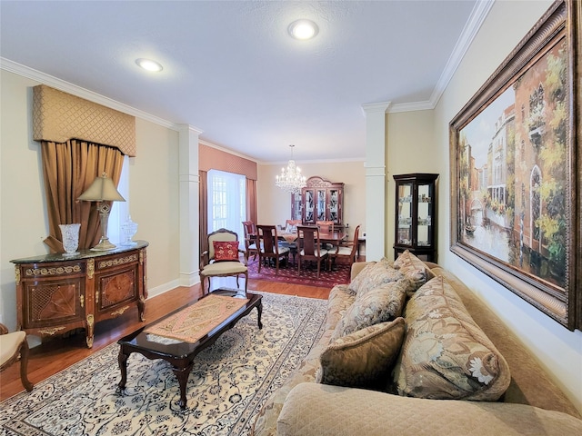 living room featuring crown molding, hardwood / wood-style floors, and an inviting chandelier