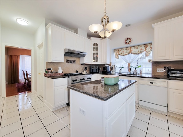 kitchen featuring dishwasher, tasteful backsplash, a kitchen island, and white cabinets