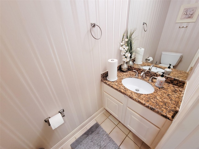 bathroom featuring tile patterned flooring, vanity, and toilet