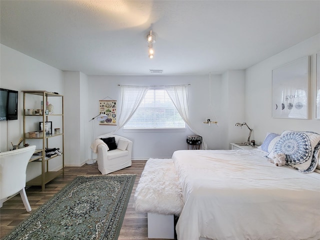 bedroom with dark hardwood / wood-style floors