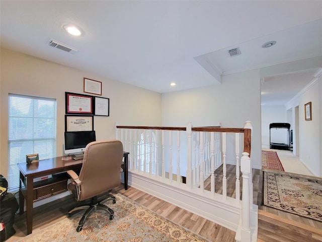 office area featuring light hardwood / wood-style flooring and crown molding