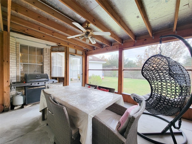 sunroom / solarium with ceiling fan and beamed ceiling