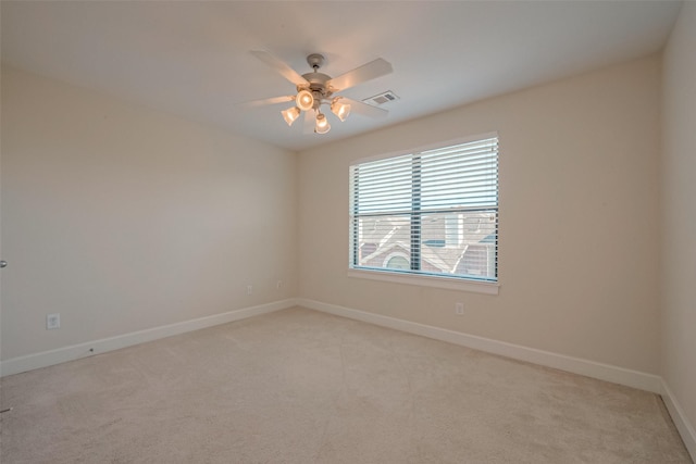 carpeted spare room with ceiling fan