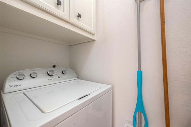 laundry room with cabinets and washer / dryer