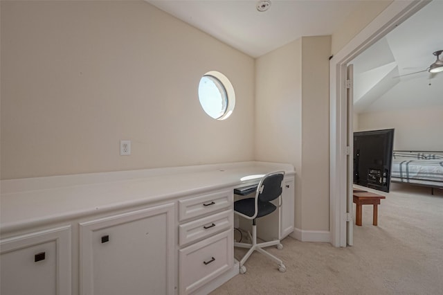 carpeted home office featuring ceiling fan