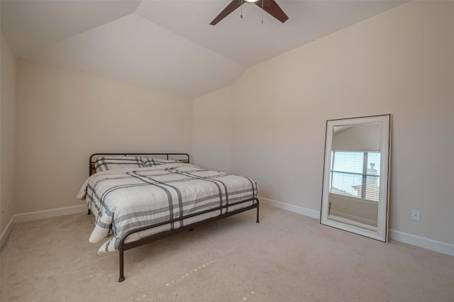 bedroom featuring ceiling fan, light carpet, and vaulted ceiling