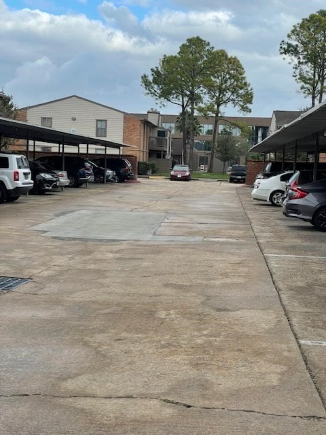 view of parking / parking lot featuring a carport