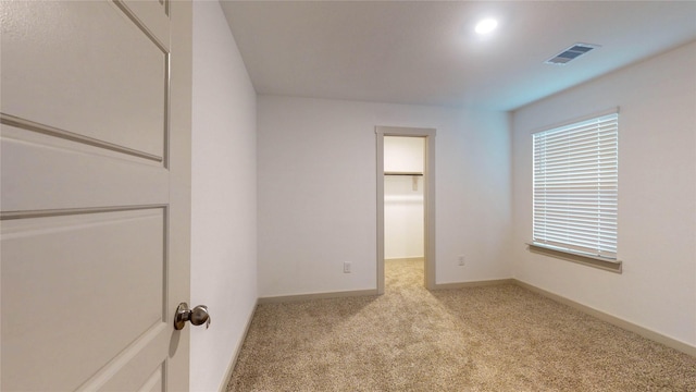 empty room featuring light carpet