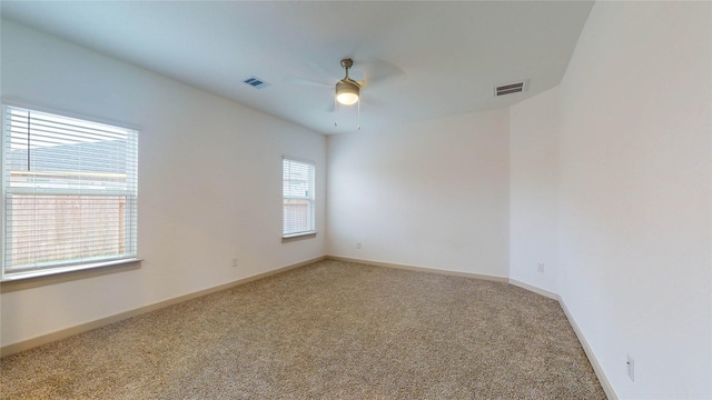 carpeted spare room with ceiling fan