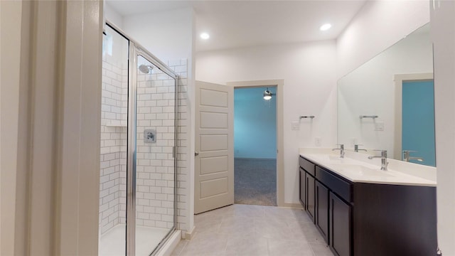 bathroom featuring tile patterned flooring, vanity, and a shower with shower door