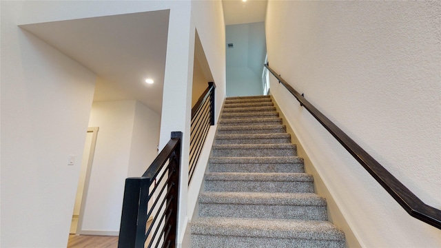 staircase featuring wood-type flooring