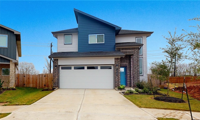 view of front of house featuring a garage and a front lawn