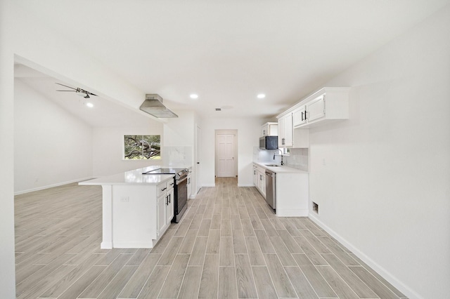 kitchen featuring white cabinets, light hardwood / wood-style floors, and stainless steel appliances