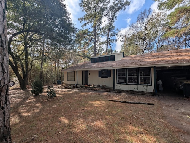 back of property with a carport