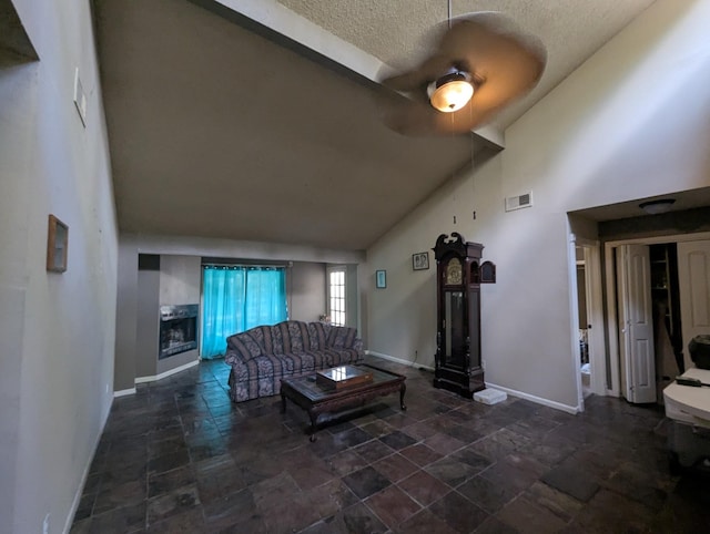 unfurnished living room with a textured ceiling and high vaulted ceiling