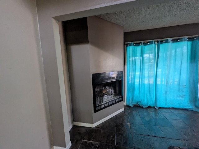 unfurnished living room with a textured ceiling