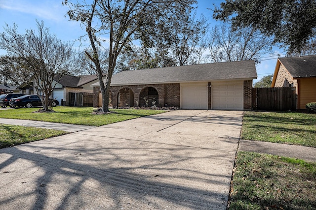 single story home with a front yard and a garage