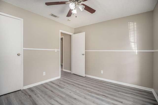 unfurnished bedroom with ceiling fan, light hardwood / wood-style flooring, and a textured ceiling