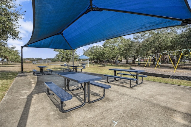 view of home's community featuring a playground and a lawn