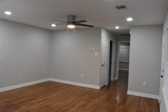 empty room with ceiling fan and dark wood-type flooring